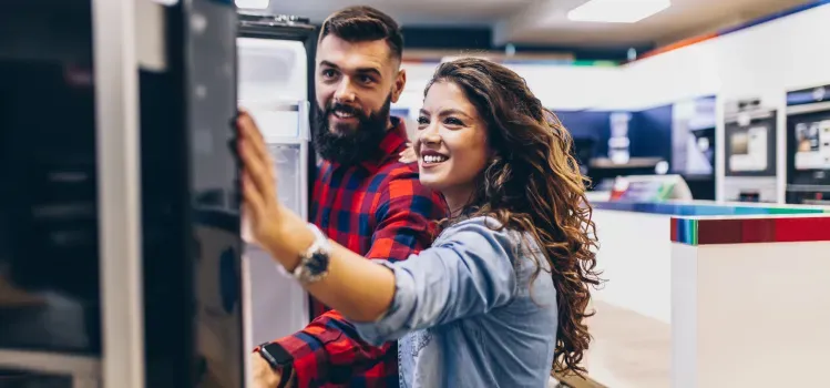 young-couple-looking-at-refrigerators
